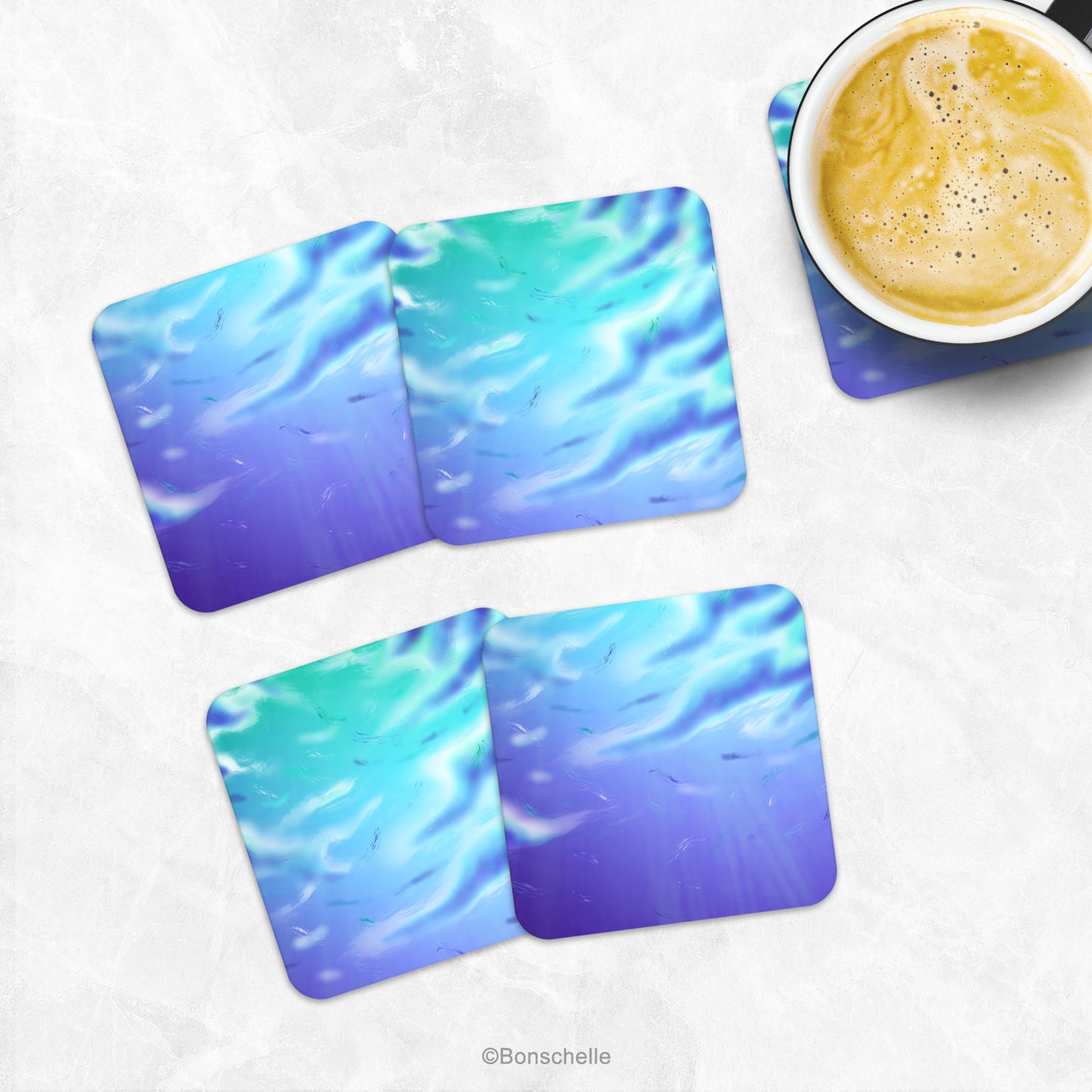 Set of 4 artistic cloud art coasters on a marble table with a cup of coffee