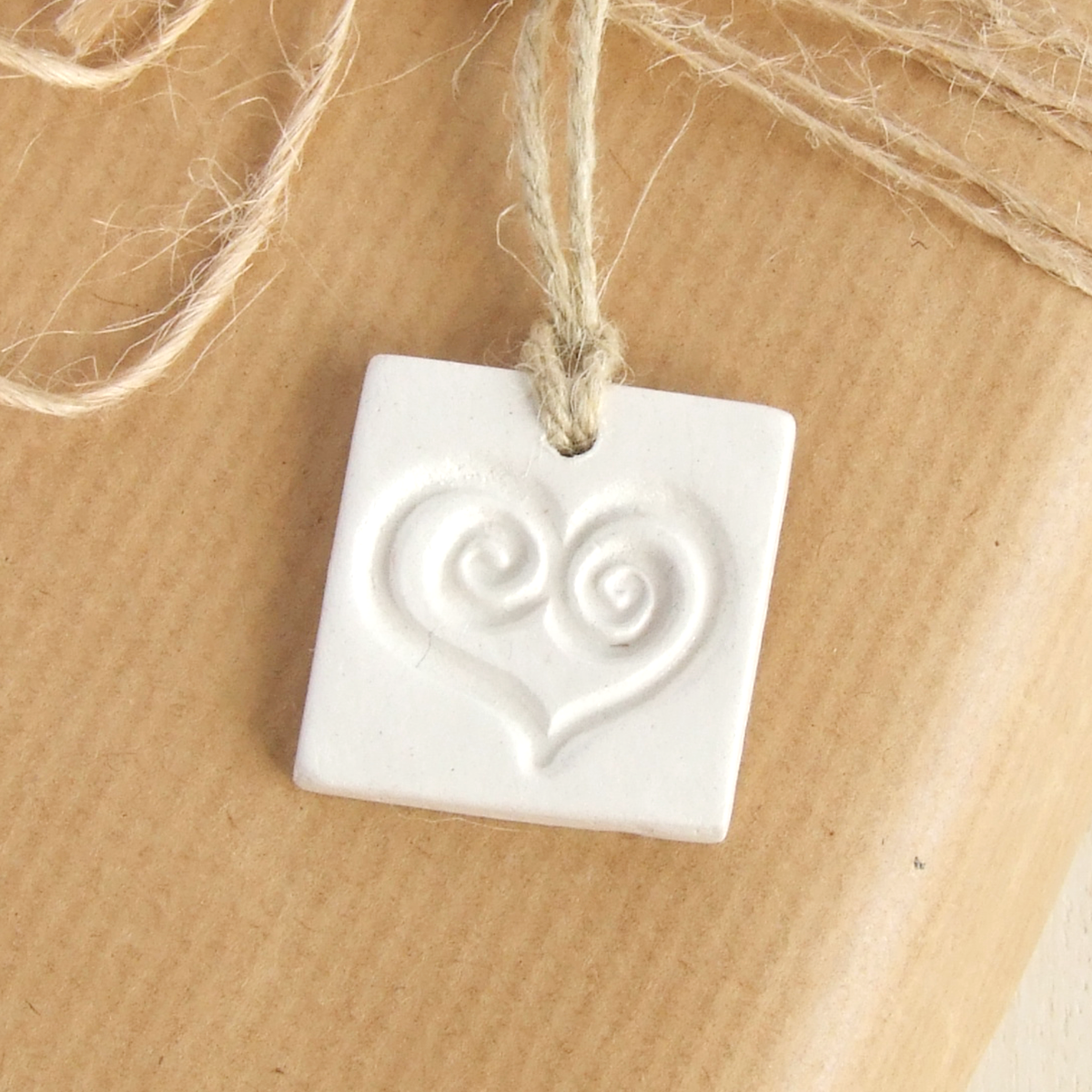 Handmade square white clay gift tags ornament with a heart imprint