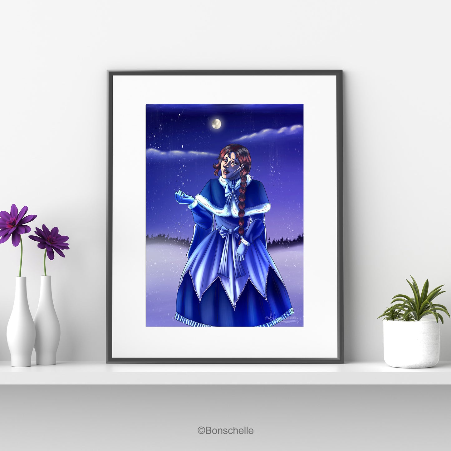 An original art print of a young girl in Lolita fashion holding her hand out to the snowflakes as they fall. The full moon glows in the background. The print is mounted on white with a black frame and sits on a white shelf. On one side are flowers in vases, on the other a cactus in a flowerpot.