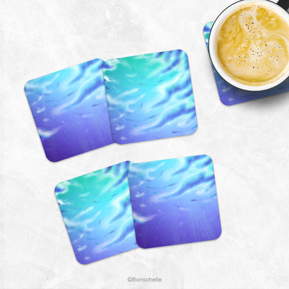 Set of 4 artistic cloud art coasters on a marble table with a cup of coffee