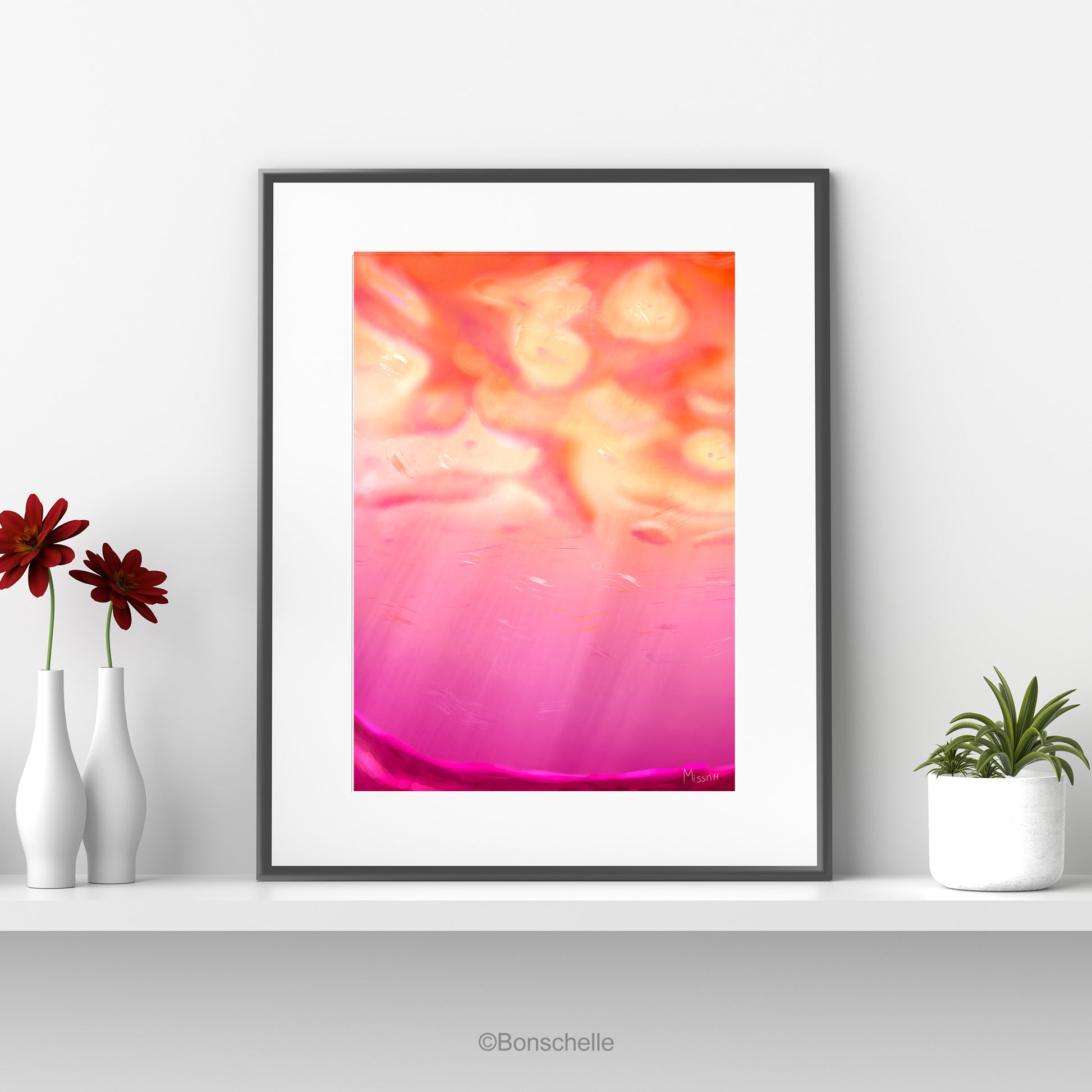 An original art print showing cloud art using the colours of the Lesbian Pride Flag. The print is mounted on a white surround and framed in black. It sits on a white shelf. On one side are flower vases, on the other a flower pot with a cactus.