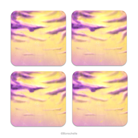 Set of four coasters with original art cloud designs in yellows and purples. Design inspired by colours of Non-Binary Pride Flag
