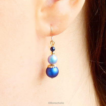 Blue swarovski crystal pearl beaded drop earrings with 14K gold filled earwires for women with gold accents shown worn on an ear