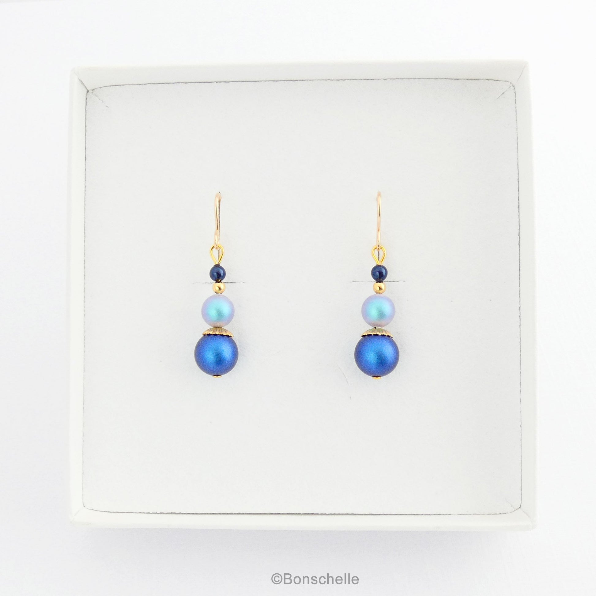 Blue swarovski crystal pearl beaded drop earrings with 14K gold filled earwires for women with gold accents shown in a jewellery box