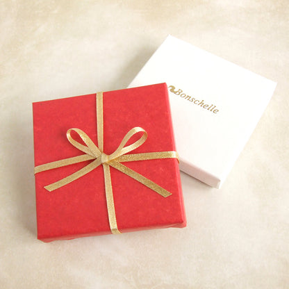 Image of a box wrapped with Bonschelle red tissue and gold bow 