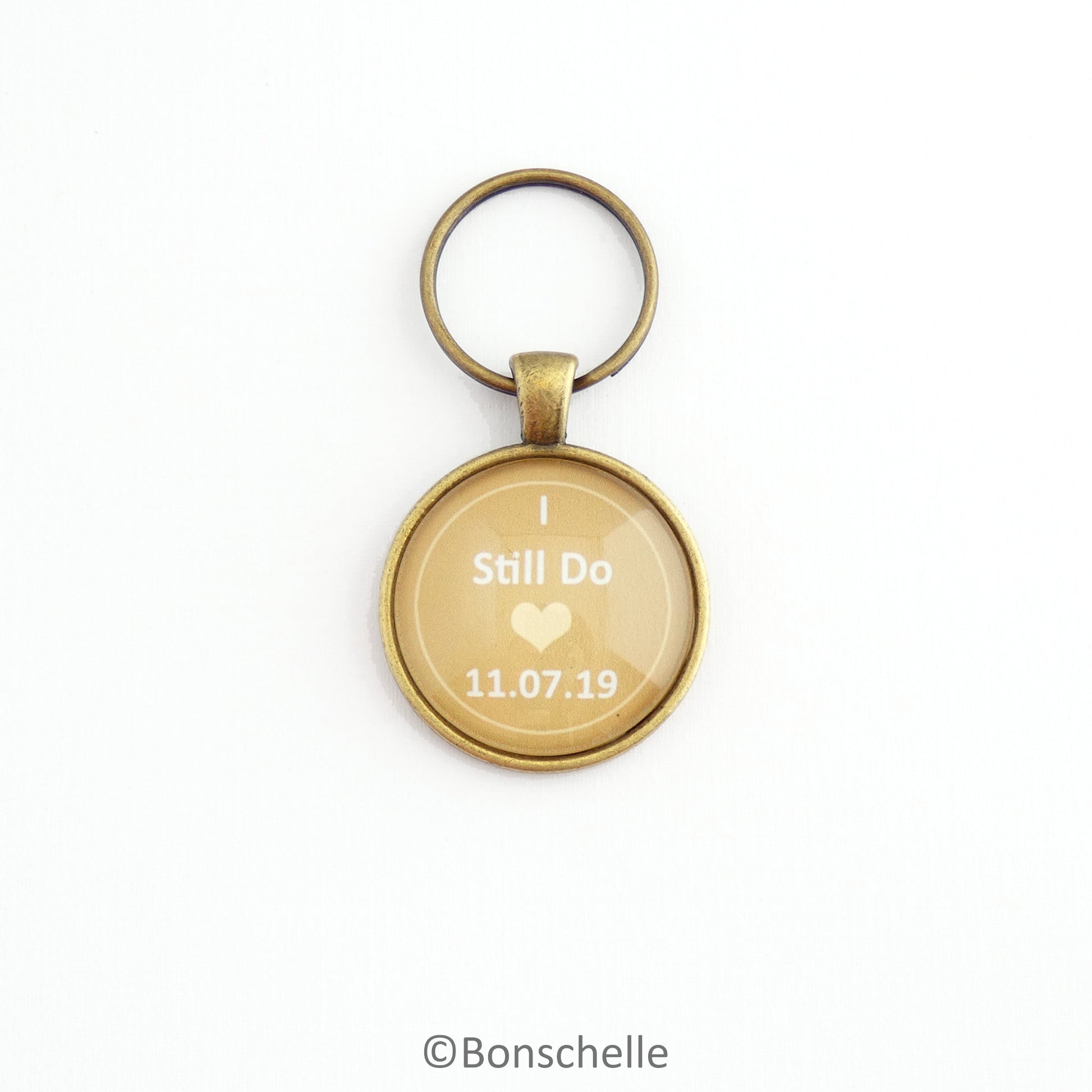 Round bronze toned anniversary keyring with the words I still Do, a small heart and a custom date 
