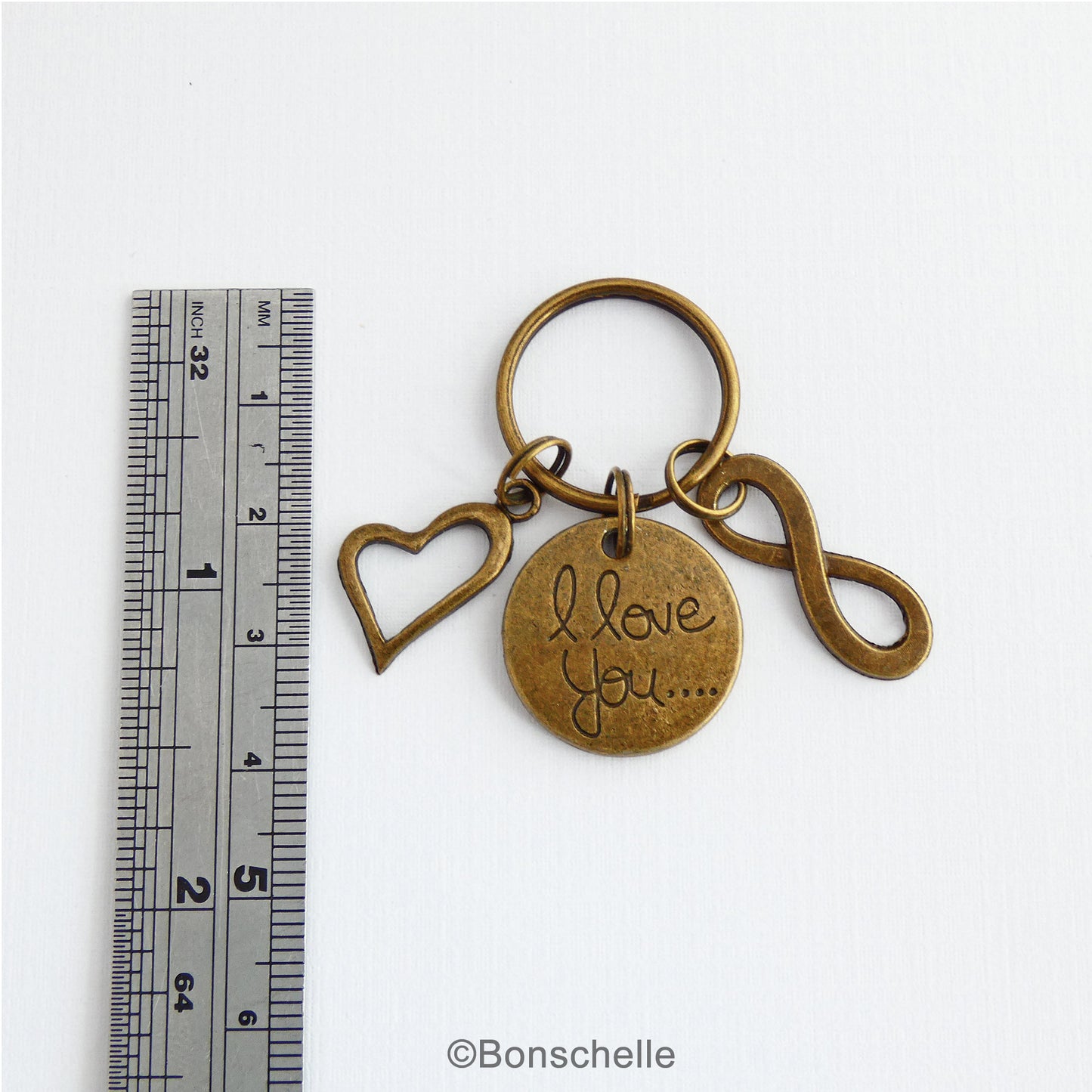 Bronze 8th anniversary keyring with an I love you charm, double heart charm and number 8 charm or infinity charm shown to scale