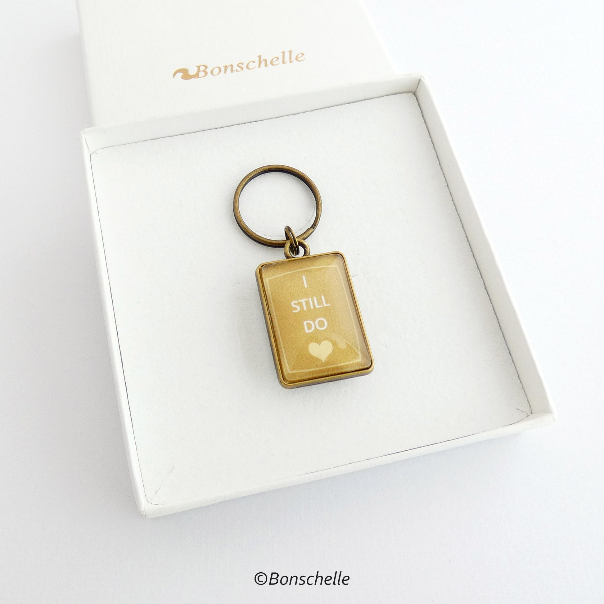gift box view of the bronze toned metal and glass cabochon rectangle shape keyring for bronze anniversary with personalised date and the worlds I still do