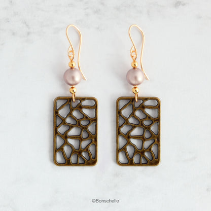 Handmade earrings made with rectangular shaped antique bronze filigree style charms, Swarovski simulated pearls in a light almond shade, gold toned beads and 14K gold filled earwires. 
