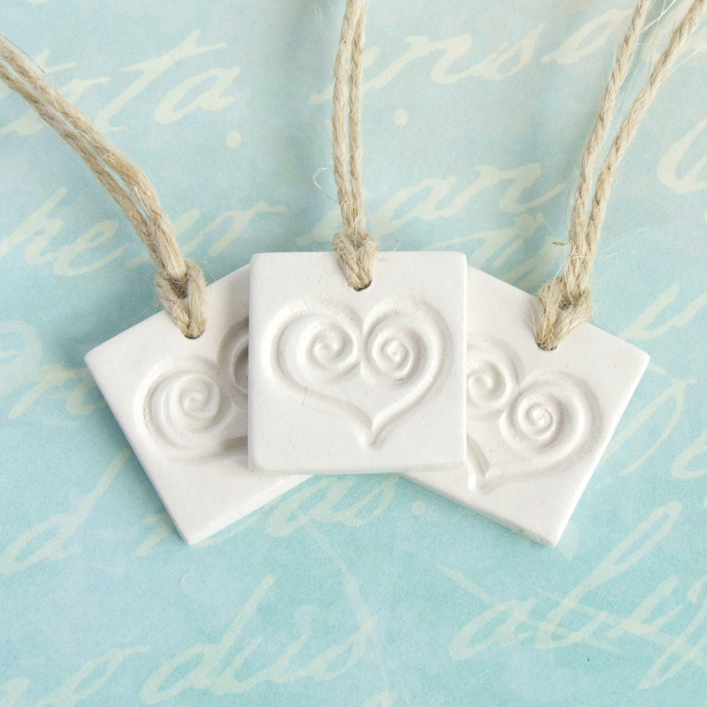 3 square white clay gift tag ornaments with heart imprint and jute ribbon