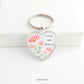Heart shaped silver keyring with pink and peach flowers flower design and the words Love You Always on the front capped with a clear glass cabochon.