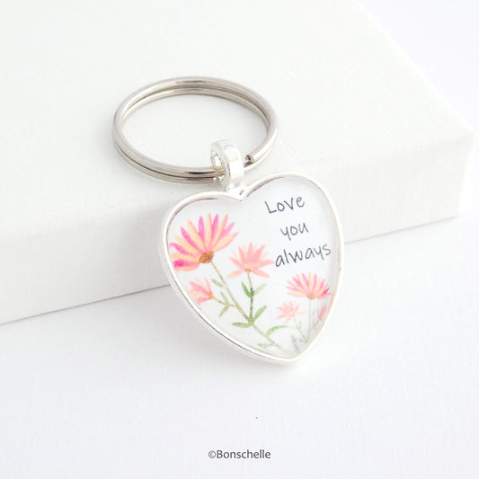 Heart shaped silver keyring with a cute flower design and the words Love You Always on the front capped with a clear glass cabochon.