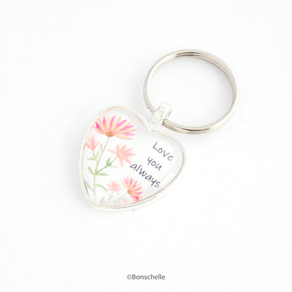 Heart shaped silver keyring with a cute flower design and the words Love You Always on the front capped with a clear glass cabochon.