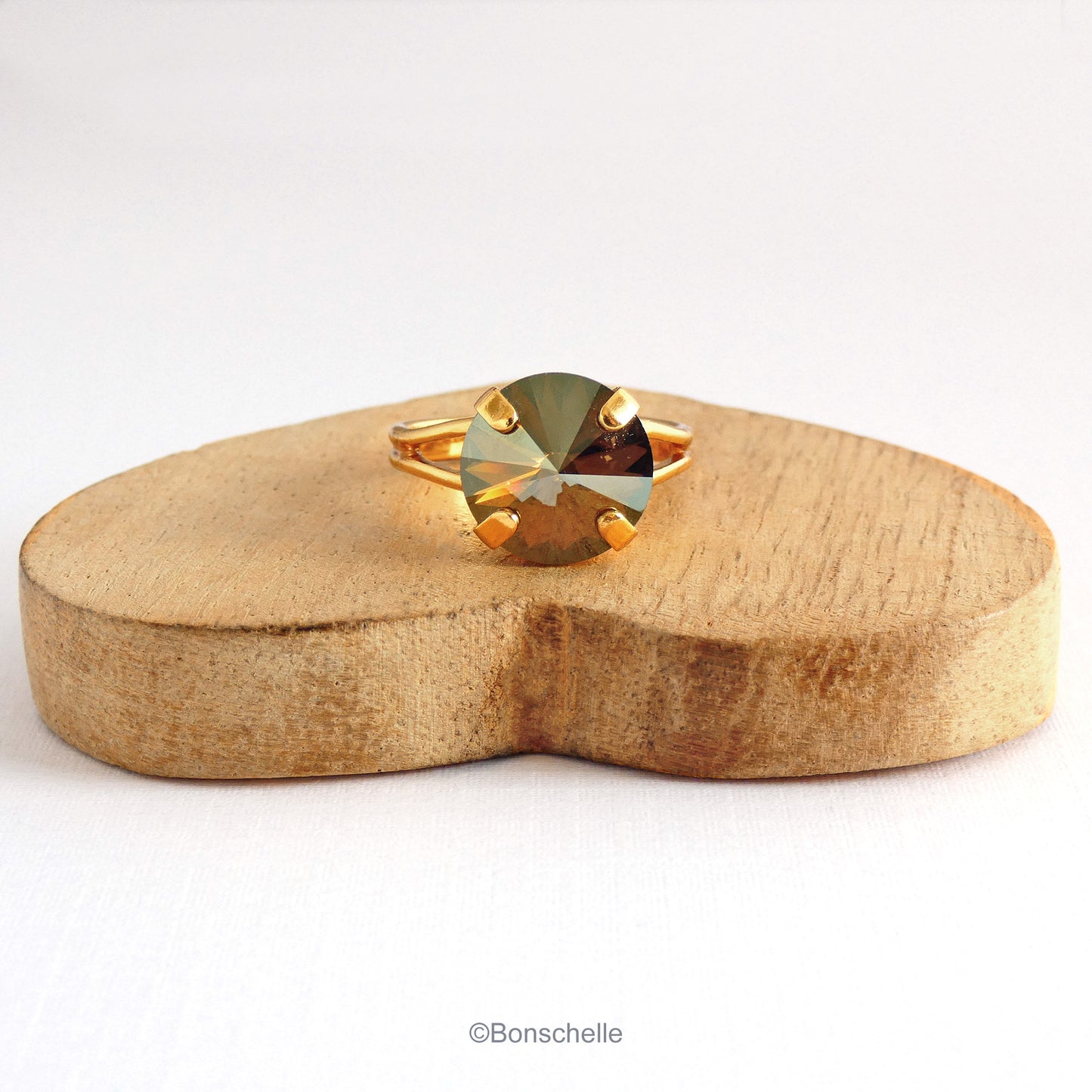 Front view of the 24K gold plate  solitaire ring for women with a deep bronze Swarovksi crystal stone.