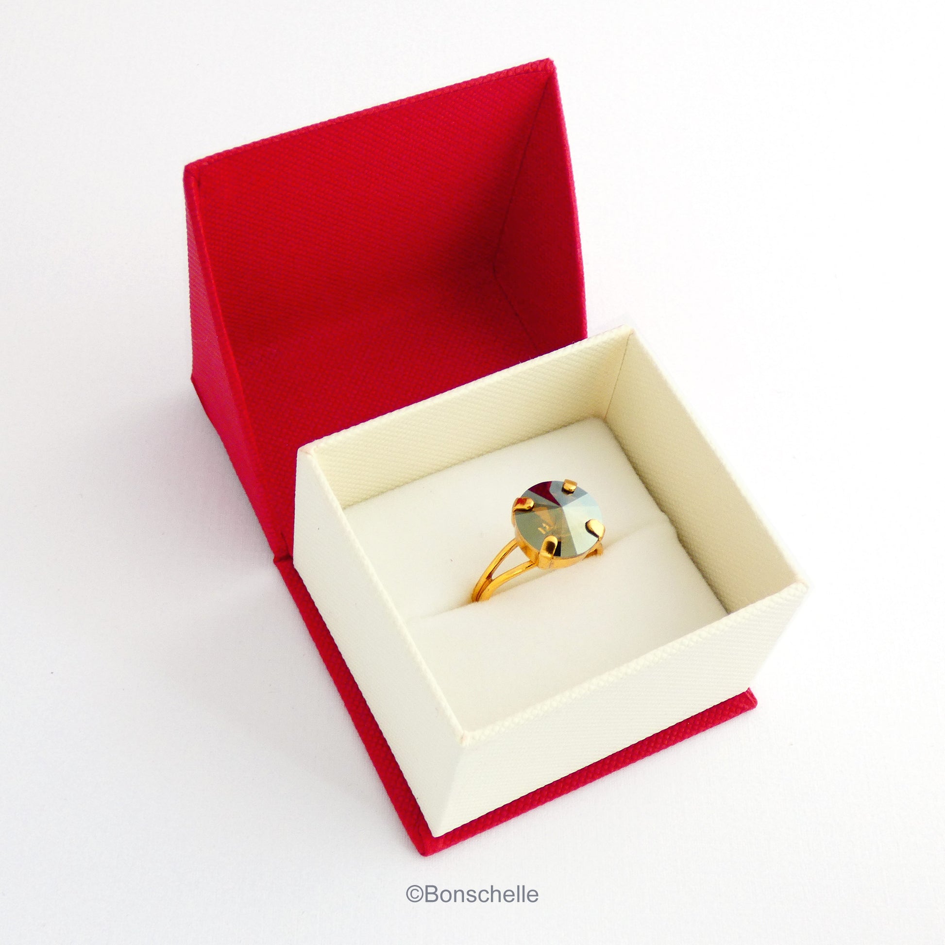 The 24K gold plated solitaire ring for women with a deep bronze Swarovksi crystal stone shown in the jewellery box.