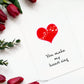 Front view of a handmade white greeting card with a red heart with white musical notes overlaid, and the words You Make My Heart Sing beneath, surrounded by roses 