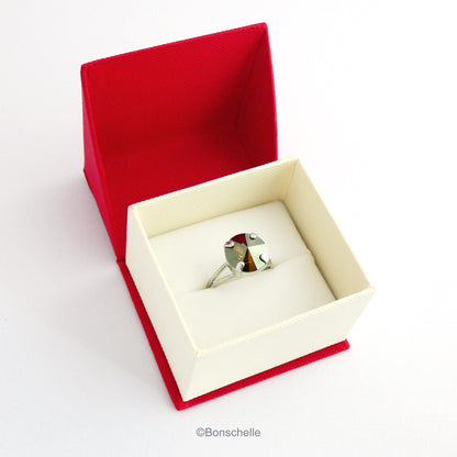 The silver toned solitaire ring for women with a deep bronze Swarovksi crystal stone shown in the jewellery box.