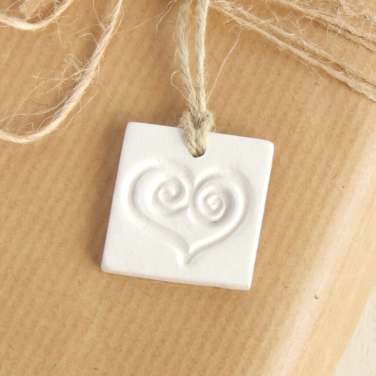 Handmade square white clay gift tags ornament with a heart imprint