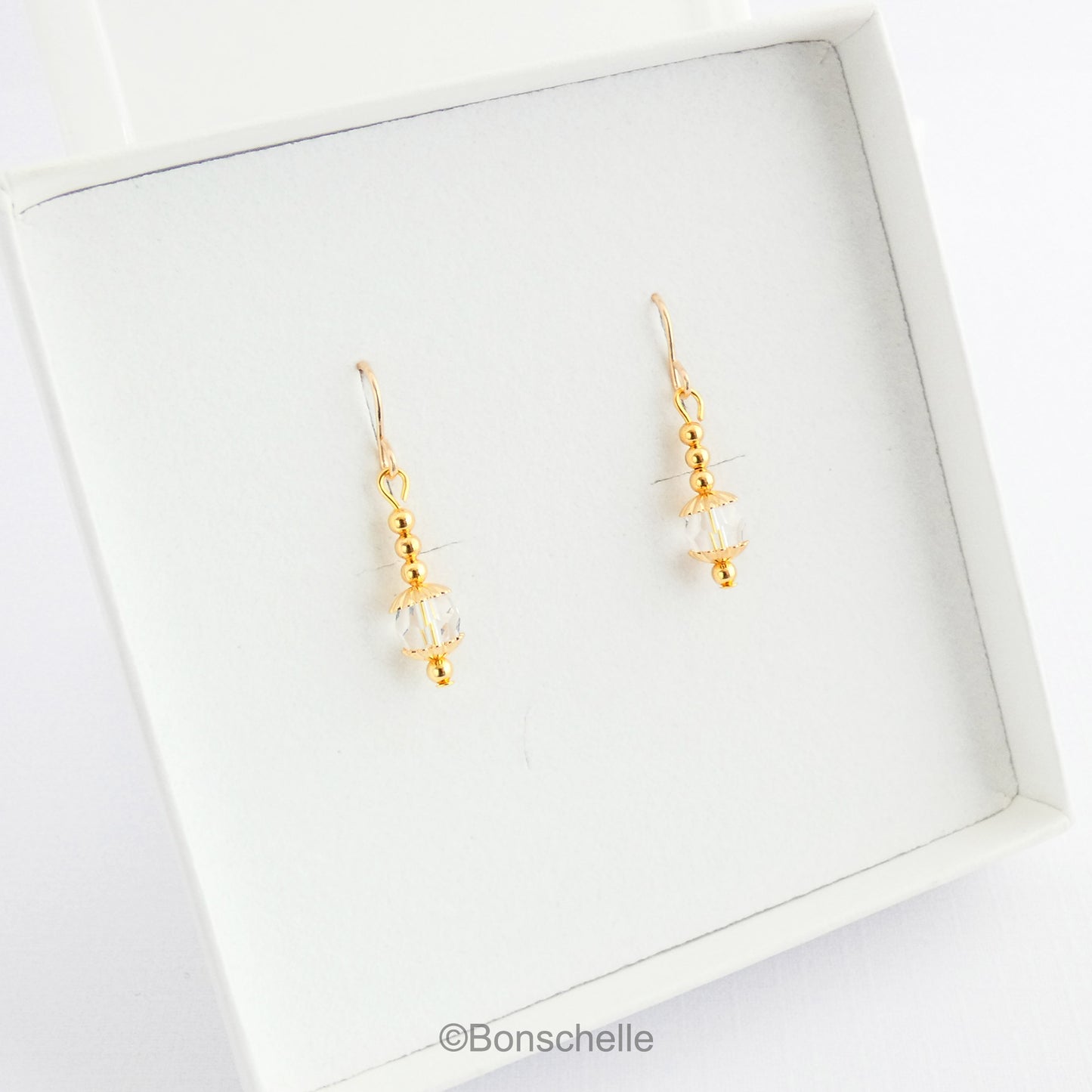 Handmade earrings with clear Swarovksi faceted crystall glass beads, gold tone small beads adn 14K gold filled earwires in a jewellery box