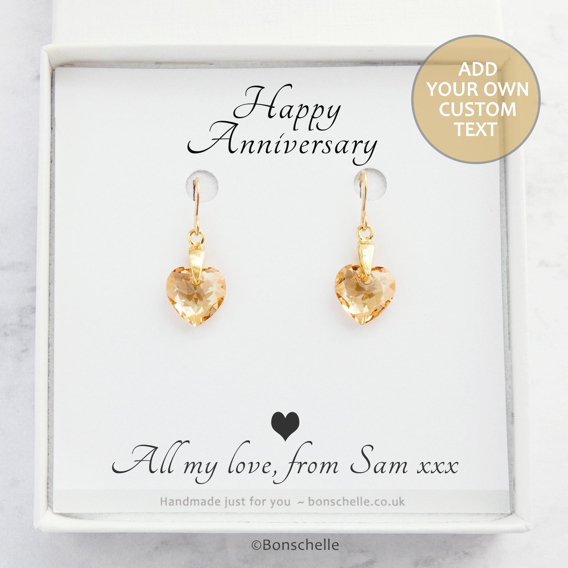 Handmade earrings with pale golden bronze toned Swarovski crystal heart earrings and 14K gold filled earwires in a jewellery box with a personalised gift message.