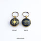 Front and back views of a personalised bronze metal round double sided keyring, with light bronze coloured compass rose on the front against a navy blue background, and the back wtih light bronze coloured text against a navy blue background.